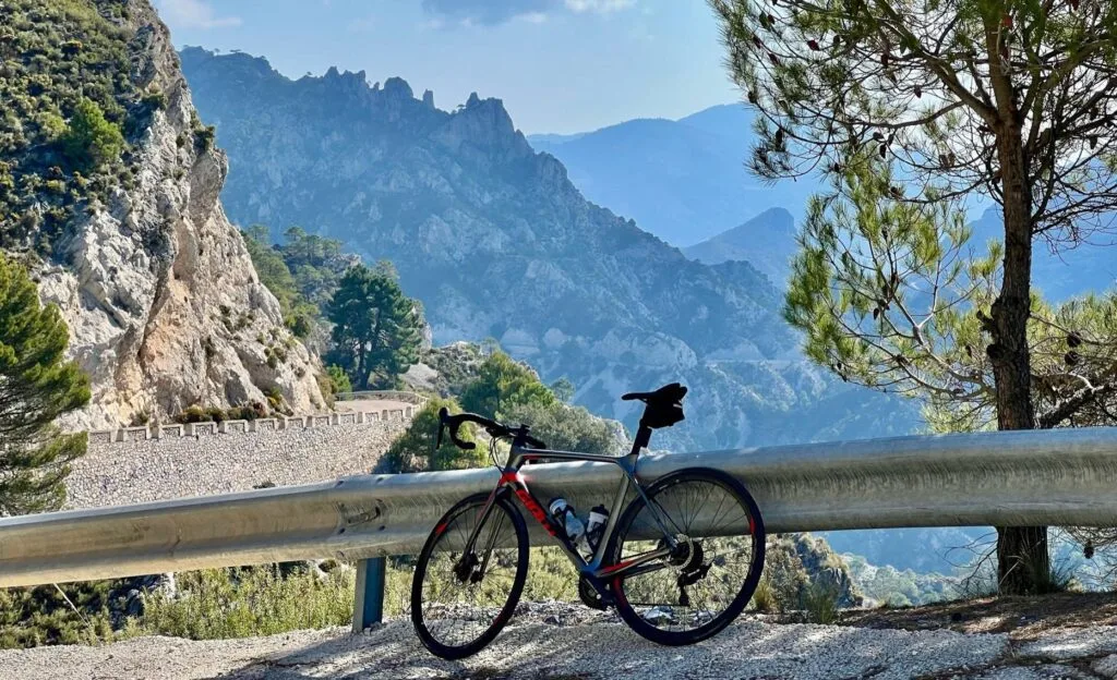 Road bike leaning against a barrier on a mountain road in the Sierra de Almijara near Nerja