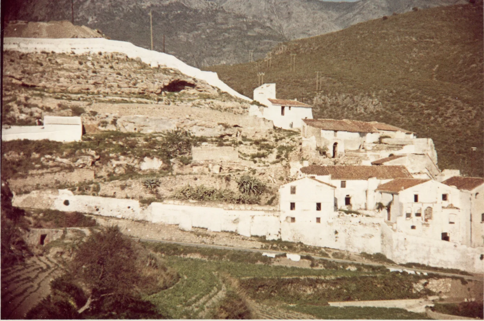 La Molineta in 1965, a complex of roofless, derelict mill buildings on the hillside below Frigiliana